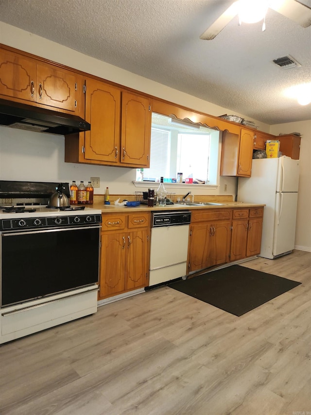 kitchen featuring a textured ceiling, white appliances, ceiling fan, and light hardwood / wood-style flooring