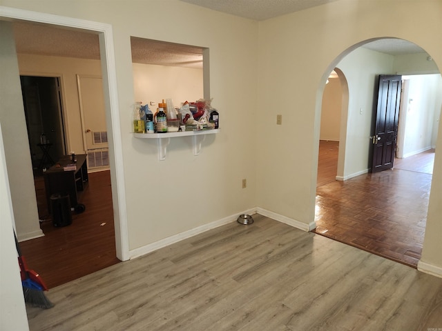 unfurnished room with hardwood / wood-style flooring