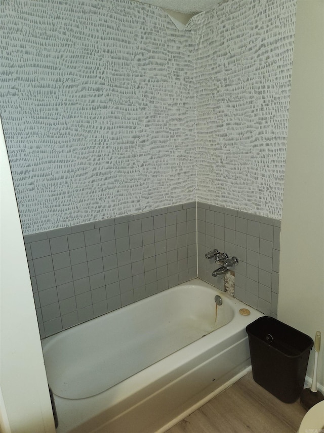 bathroom featuring a washtub and hardwood / wood-style floors