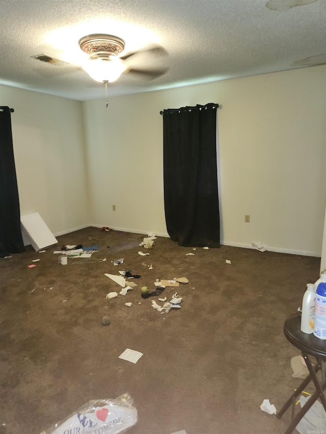 unfurnished room featuring ceiling fan and a textured ceiling