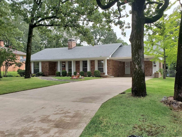 single story home with a front lawn and a carport