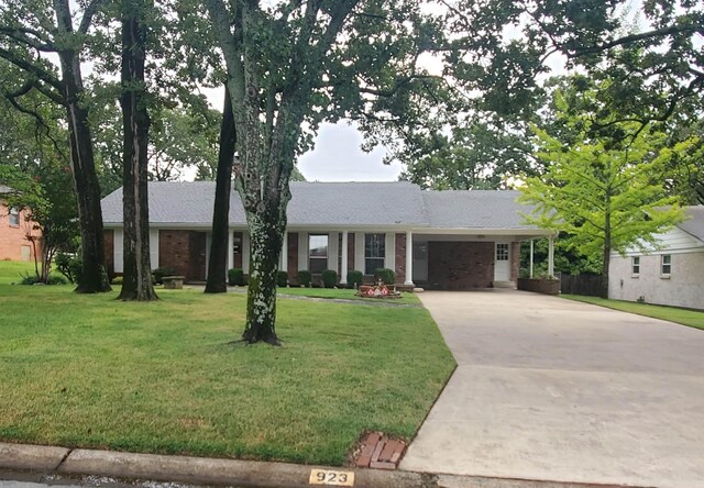 ranch-style home with a carport and a front yard