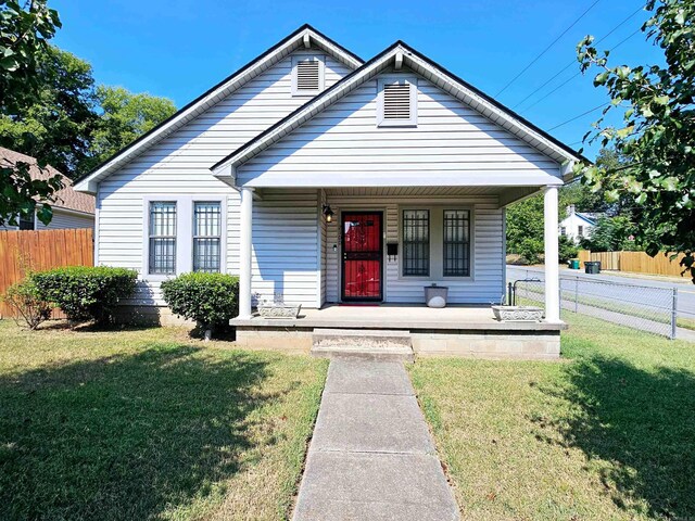 bungalow featuring a front lawn and covered porch