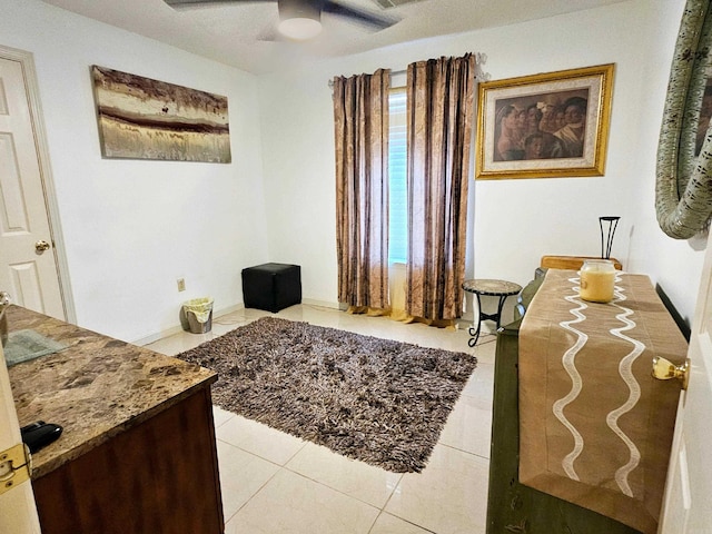 bedroom featuring light tile patterned floors and a ceiling fan