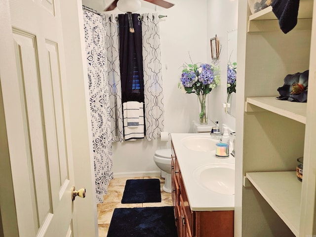 bathroom featuring a sink, toilet, and double vanity