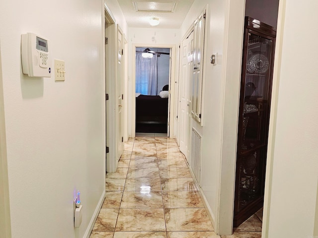 hall featuring marble finish floor, visible vents, and baseboards