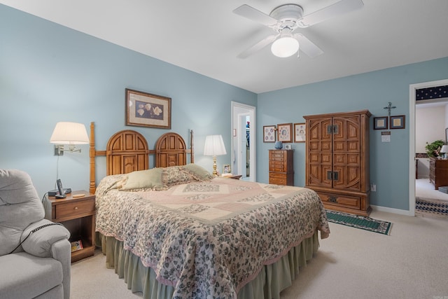 bedroom with a ceiling fan and light colored carpet
