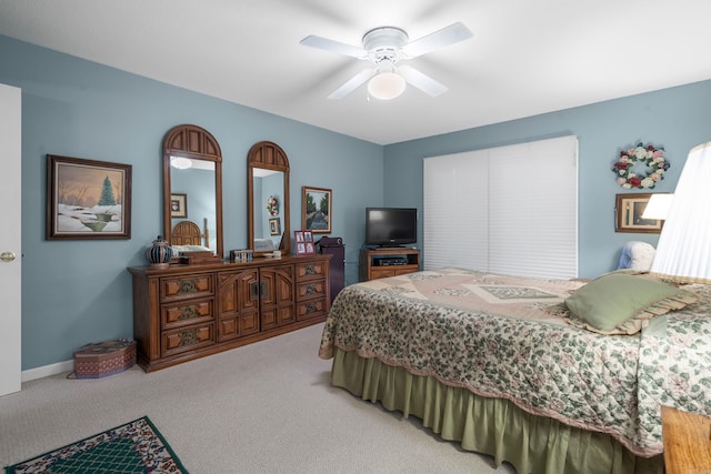 bedroom featuring a ceiling fan and light carpet