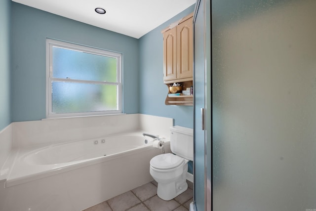 bathroom featuring tile patterned floors, toilet, and a bath