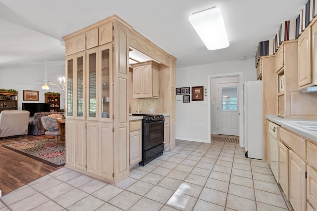 kitchen featuring light tile patterned flooring, light brown cabinetry, and white appliances