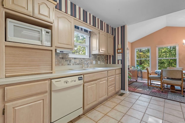 kitchen featuring light tile patterned floors, light countertops, light brown cabinetry, and white appliances