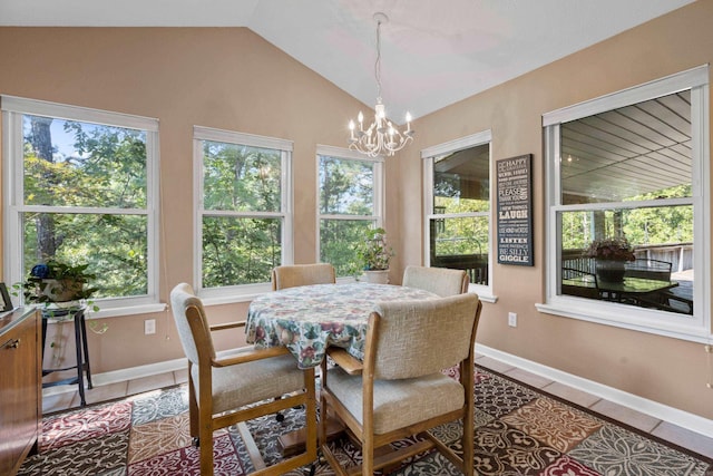 tiled dining area featuring a chandelier, lofted ceiling, and plenty of natural light