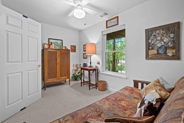 living area with baseboards, visible vents, a ceiling fan, and carpet floors