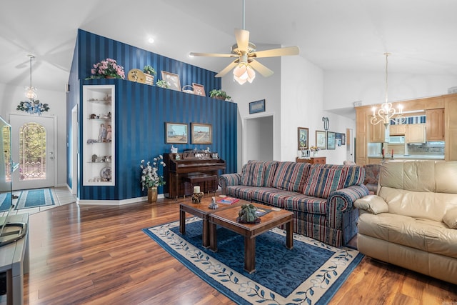 living room featuring wood finished floors, high vaulted ceiling, and ceiling fan with notable chandelier