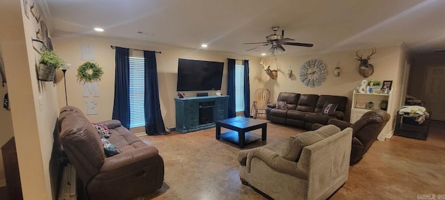 living room with crown molding, ceiling fan, and plenty of natural light