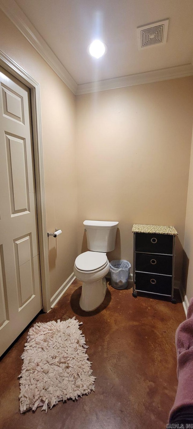 bathroom featuring ornamental molding and toilet