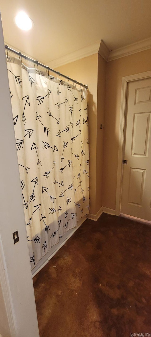 bathroom with ornamental molding and a shower with shower curtain