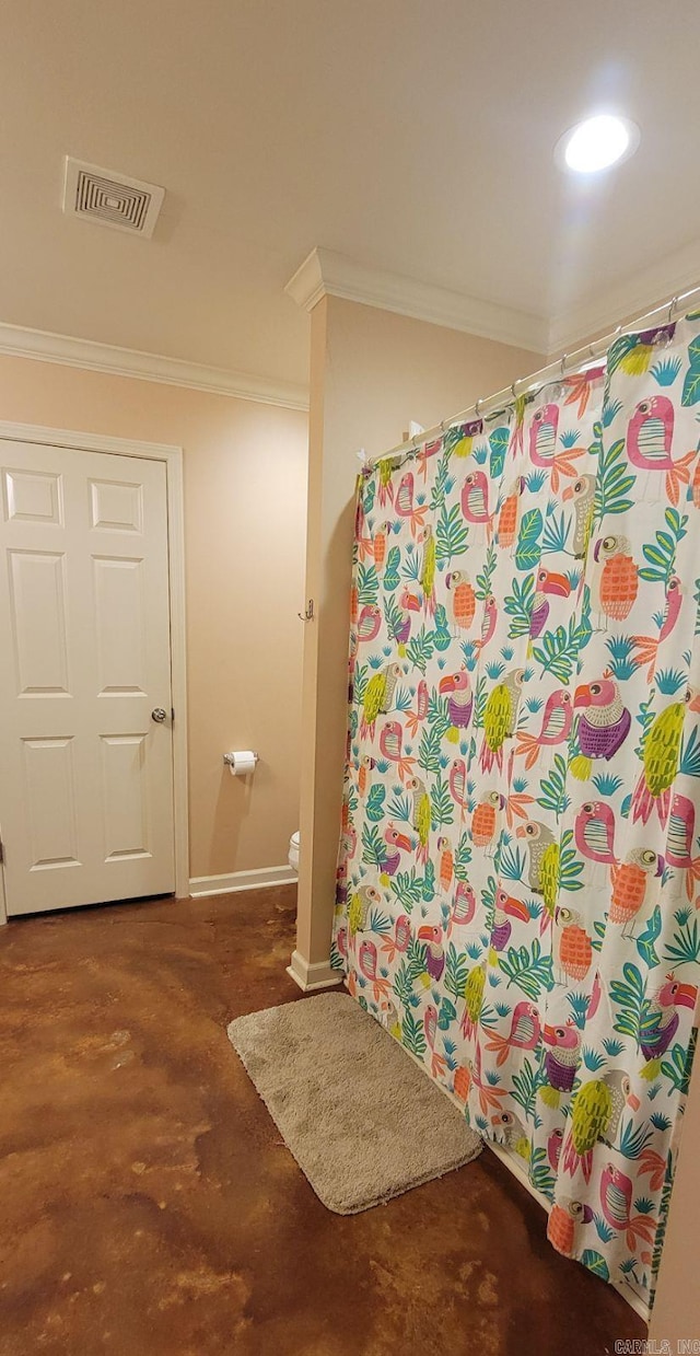 bathroom featuring ornamental molding and walk in shower