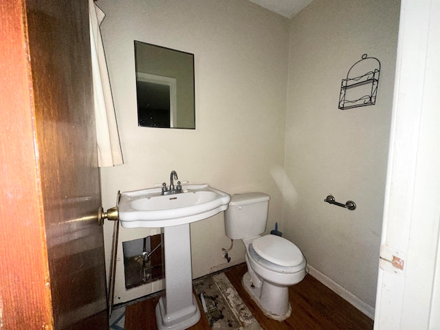 bathroom featuring hardwood / wood-style floors and toilet