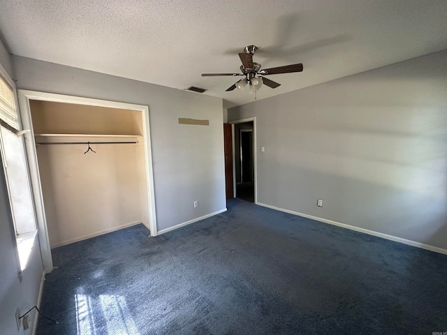 unfurnished bedroom featuring a textured ceiling, a closet, ceiling fan, and carpet