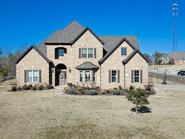 french country inspired facade with a front lawn