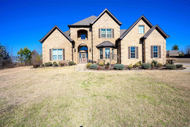 french country inspired facade with a front yard