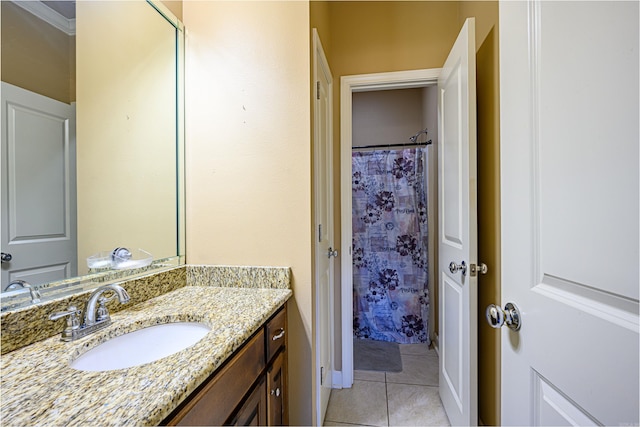 bathroom featuring tile patterned floors, vanity, walk in shower, and ornamental molding