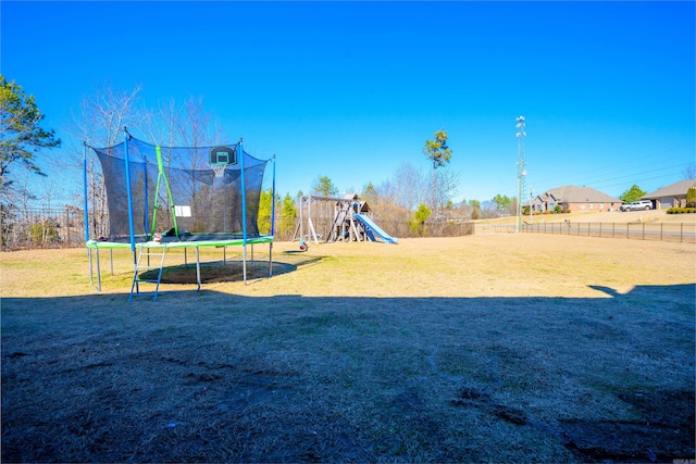 view of yard with a trampoline and a playground