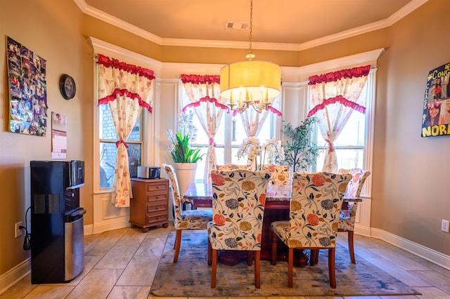 tiled dining area featuring crown molding and an inviting chandelier