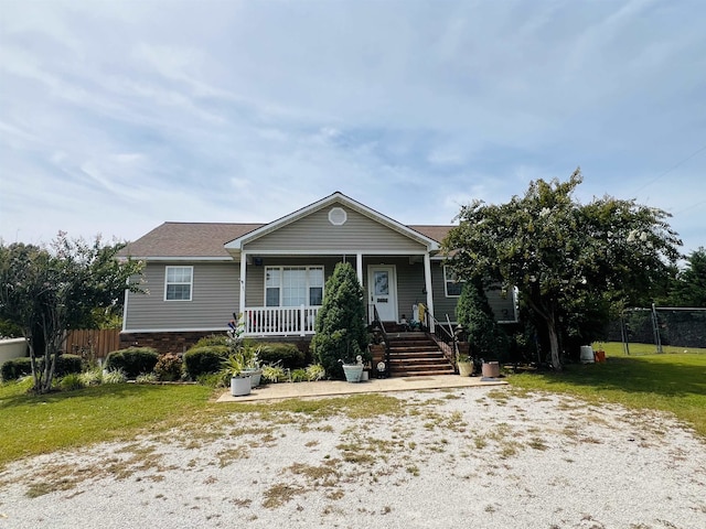 view of front of home with a porch and a front lawn