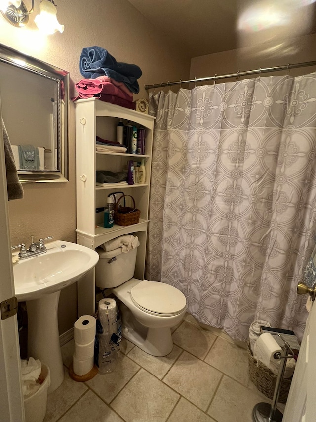 bathroom featuring tile patterned flooring and toilet