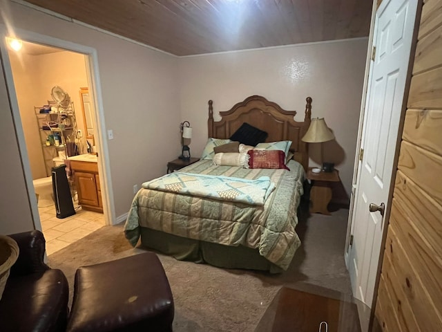 tiled bedroom with wood ceiling and connected bathroom