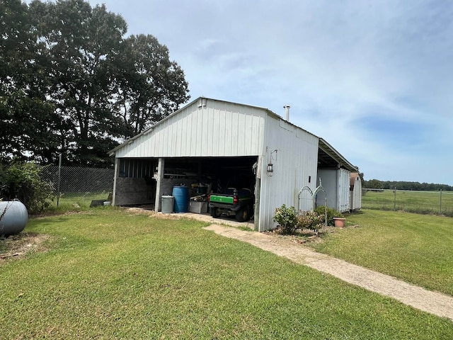 view of outdoor structure featuring a lawn