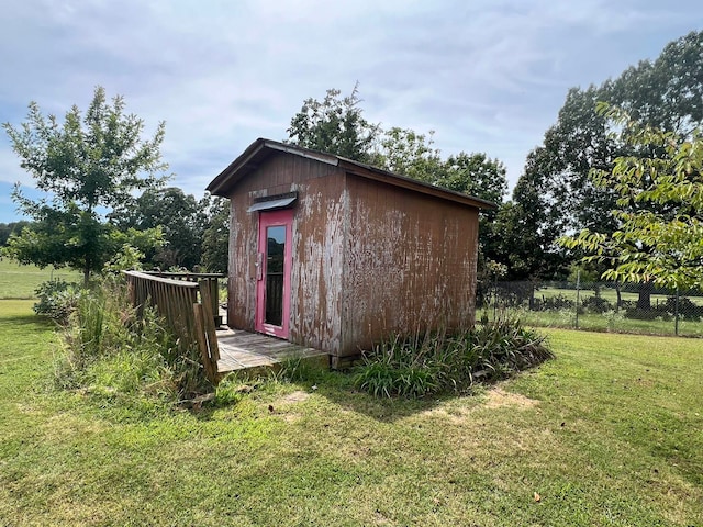 view of outbuilding featuring a lawn