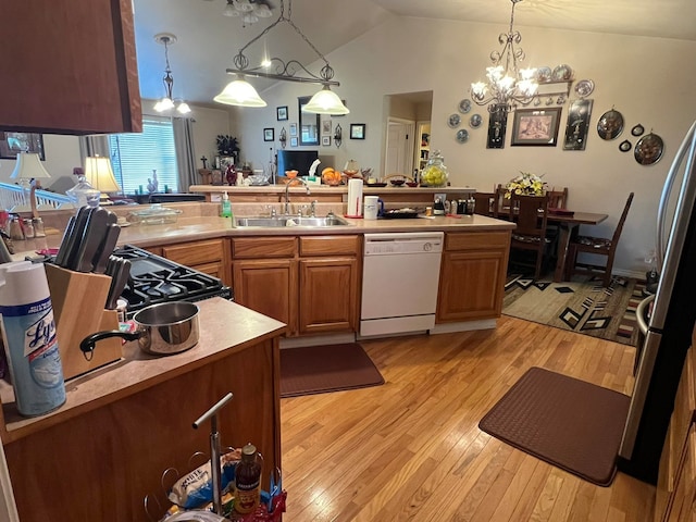 kitchen with kitchen peninsula, light hardwood / wood-style floors, white dishwasher, and lofted ceiling