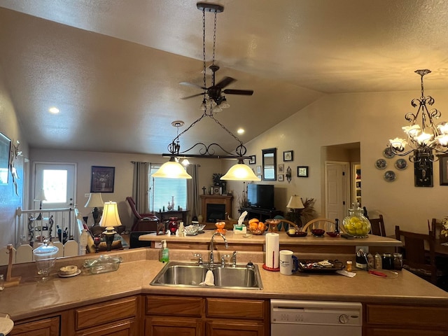 kitchen with sink, lofted ceiling, pendant lighting, and white dishwasher