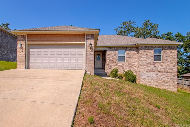 view of front of home featuring a garage and a front yard