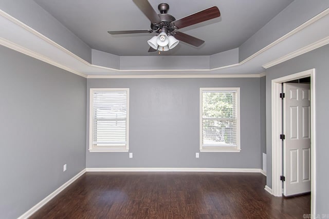 empty room featuring ceiling fan, a raised ceiling, crown molding, and wood-type flooring