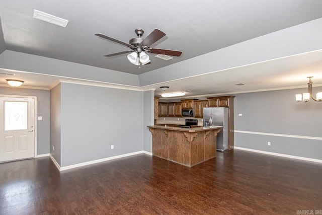 kitchen featuring a breakfast bar, ornamental molding, dark wood-type flooring, stainless steel appliances, and kitchen peninsula