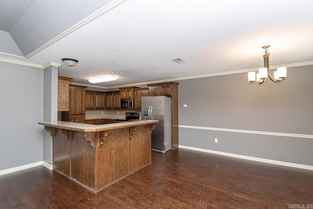 kitchen with stainless steel appliances, dark wood-type flooring, decorative light fixtures, and ornamental molding