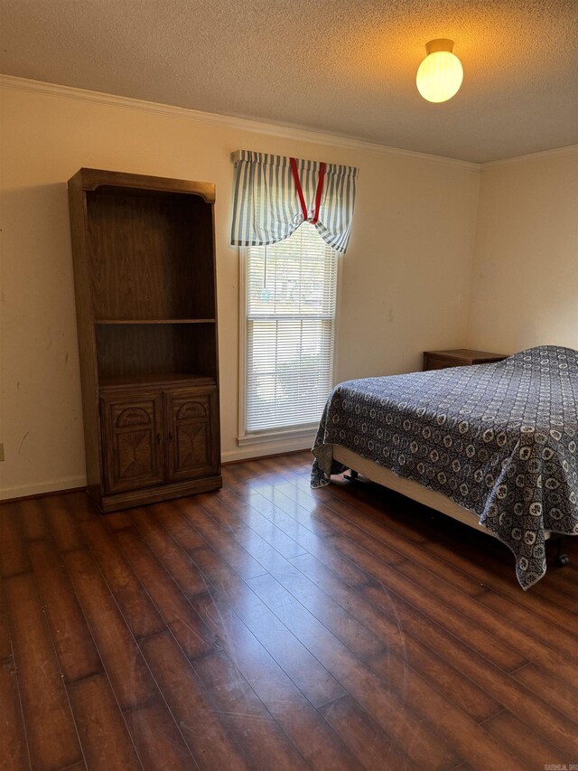 bedroom featuring ornamental molding, a textured ceiling, and dark hardwood / wood-style flooring