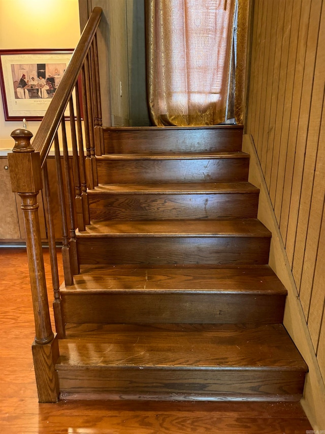 staircase featuring wood-type flooring