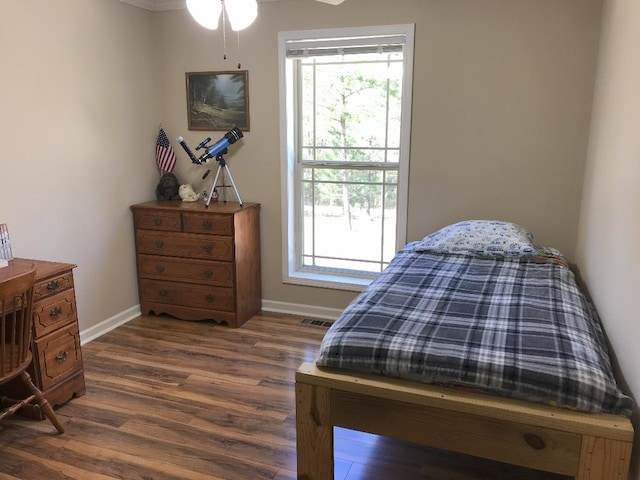 bedroom with dark hardwood / wood-style floors