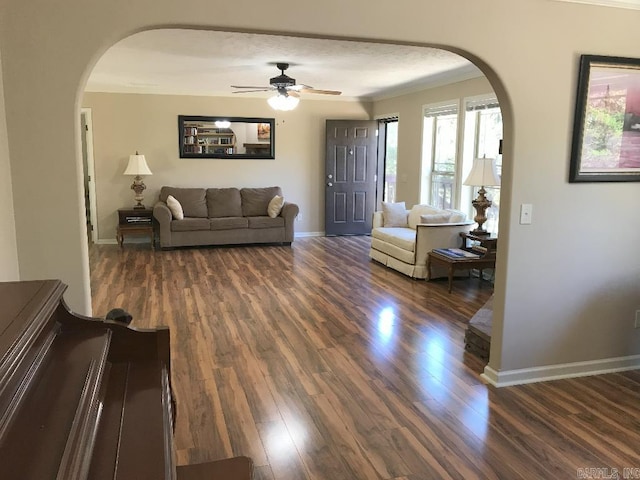 living room with ceiling fan and dark wood-type flooring