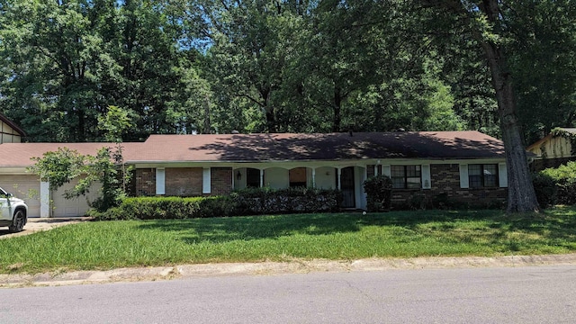 ranch-style house with brick siding, a garage, and a front yard