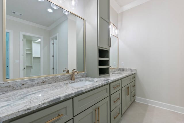 bathroom featuring tile patterned flooring, crown molding, and vanity