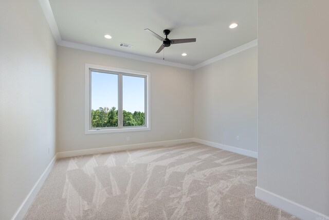 carpeted empty room featuring ceiling fan and crown molding