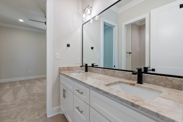 bathroom featuring crown molding and vanity