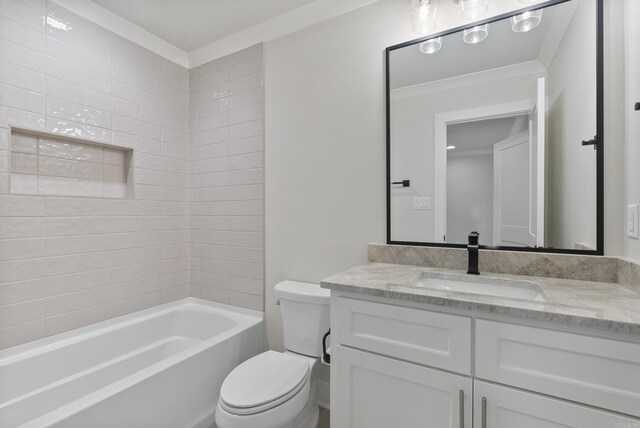 full bathroom with crown molding, vanity, tiled shower / bath, and toilet