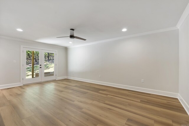 spare room with light hardwood / wood-style flooring, ceiling fan, crown molding, and french doors